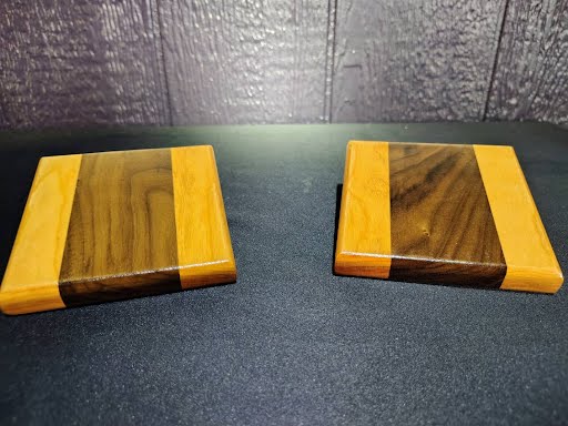 Set of 4 walnut and cherry hardwood coasters side by side