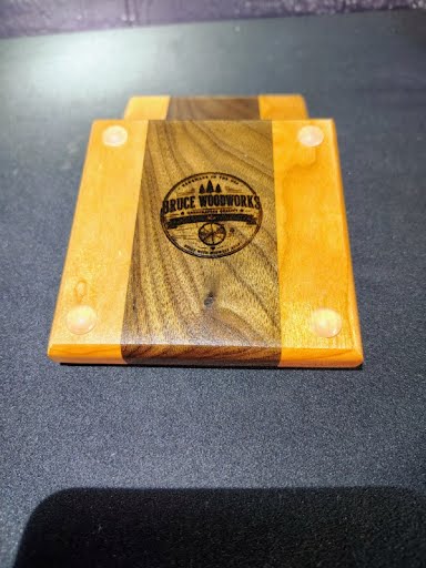 Coaster bottom showing Bruce WoodWorks branded logo and non-slip feet