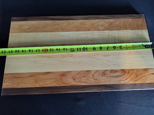 Handmade maple, cherry and walnut cutting board - top view showing natural grain