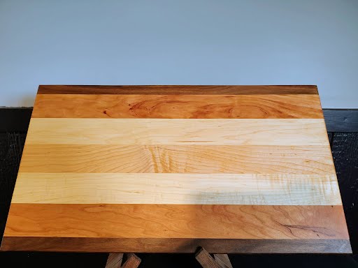 Cutting board top view on light background showing full surface