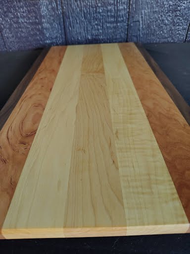 Cutting board angled view showing walnut border and maple center